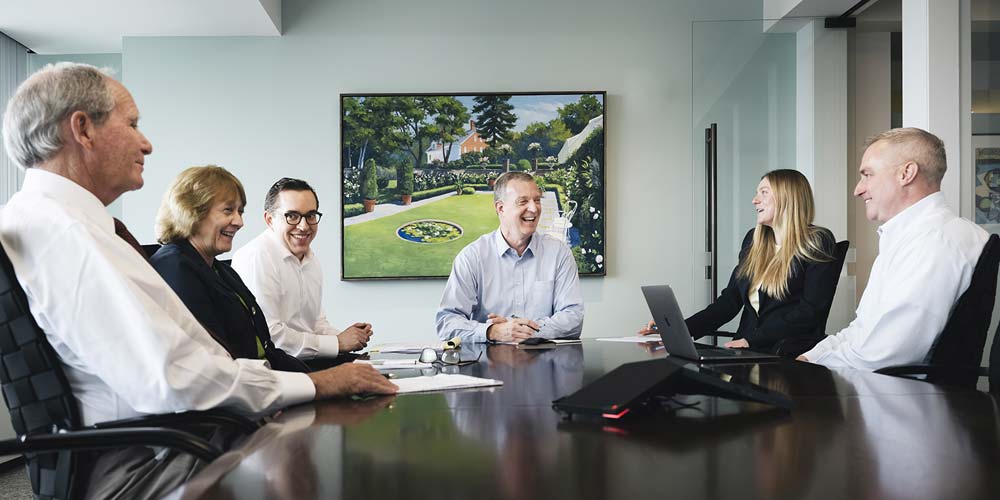 Middleton & Company is different Middleton team sitting together art conference table
